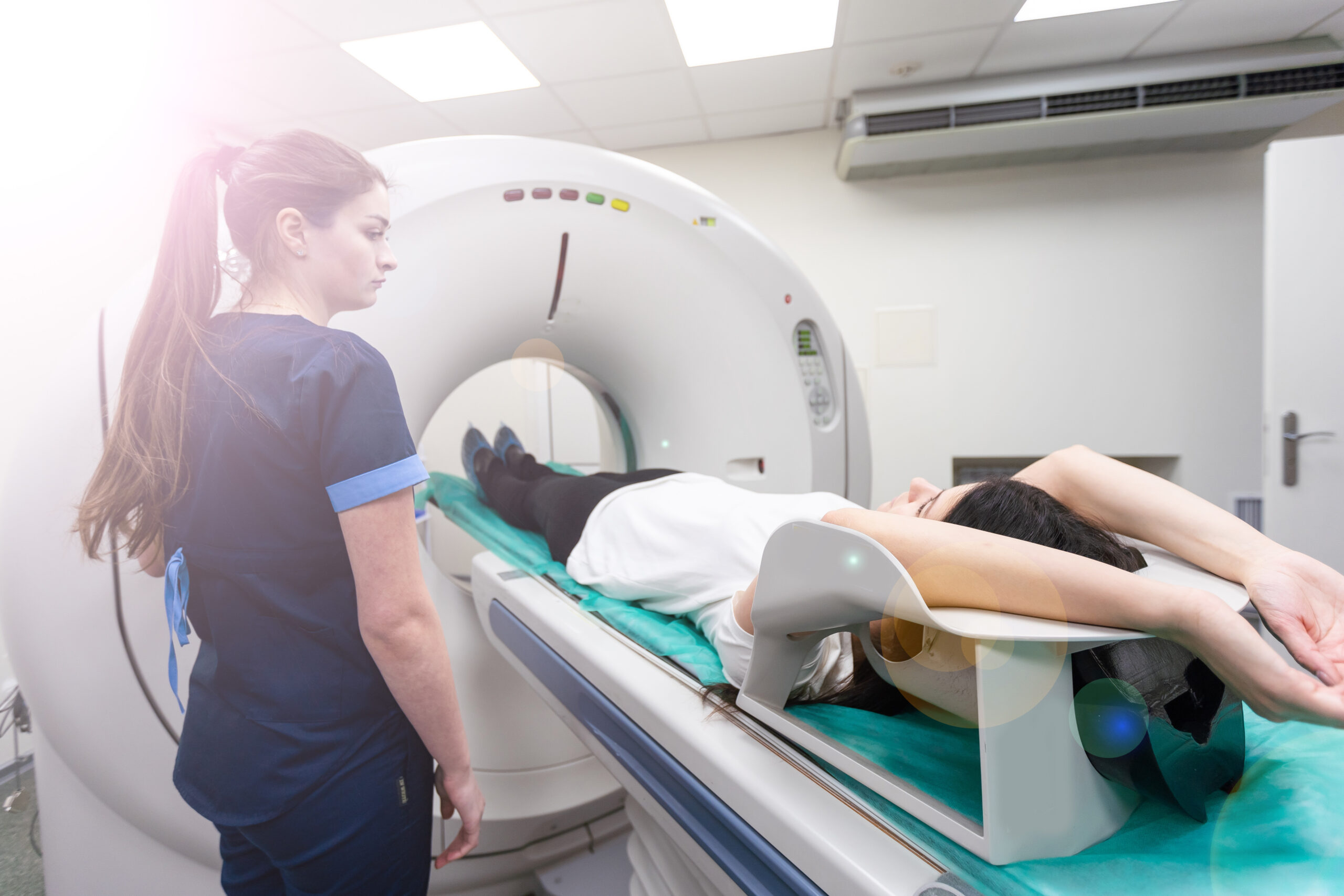 Radiologic technician and Patient being scanned and diagnosed on CT scanner